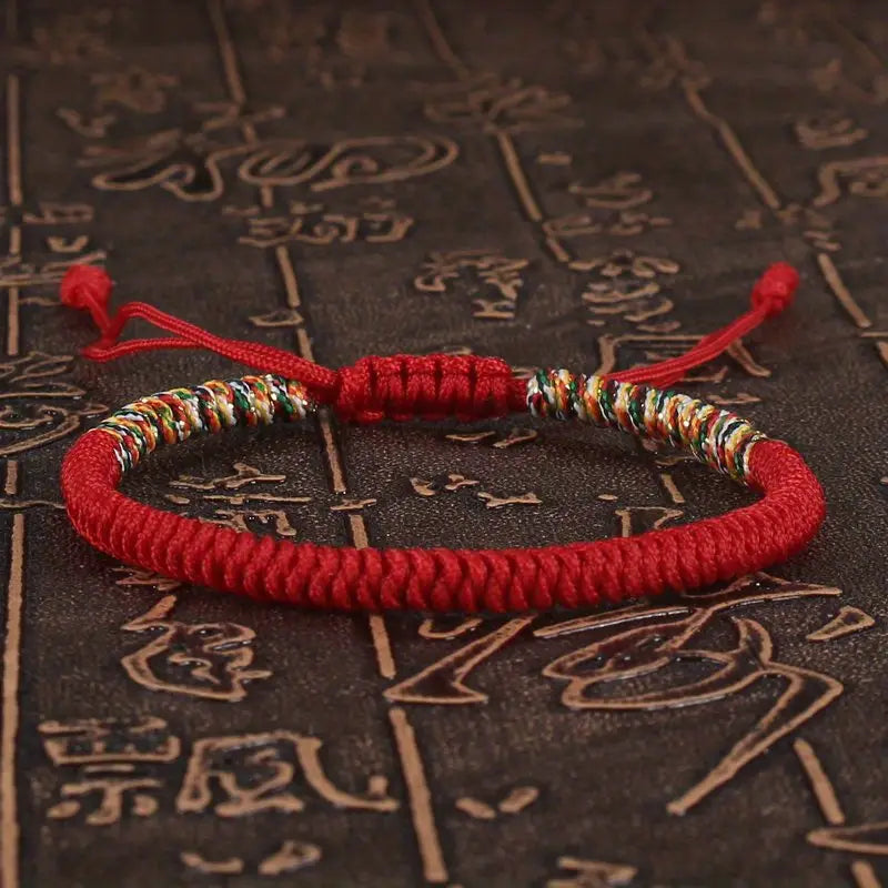 PULSERA TRENZADA BUDISTA CON DETALLE DE HILO MULTICOLOR