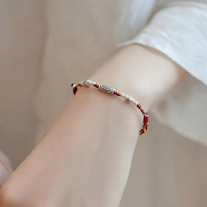 PULSERA DE HILO TRENZADA CON DIJE DE PEZ DE VIDA