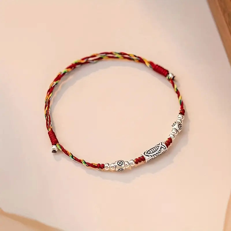 PULSERA DE HILO TRENZADA CON DIJE DE PEZ DE VIDA