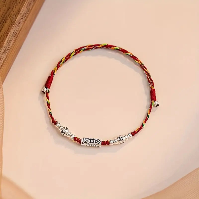 PULSERA DE HILO TRENZADA CON DIJE DE PEZ DE VIDA